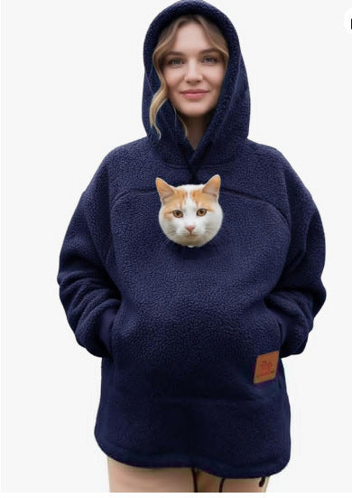 Navy blue sherpa fleece pet pouch hoodie front view on a woman with a cat in the pouch