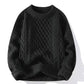 Cable knit crewneck pullover laid flat, raised braided panels running down the front and sleeves