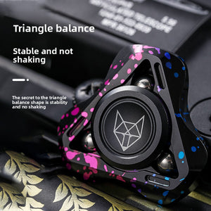 Metal fox fidget spinner closeup showing splatter finish and fox logo cap