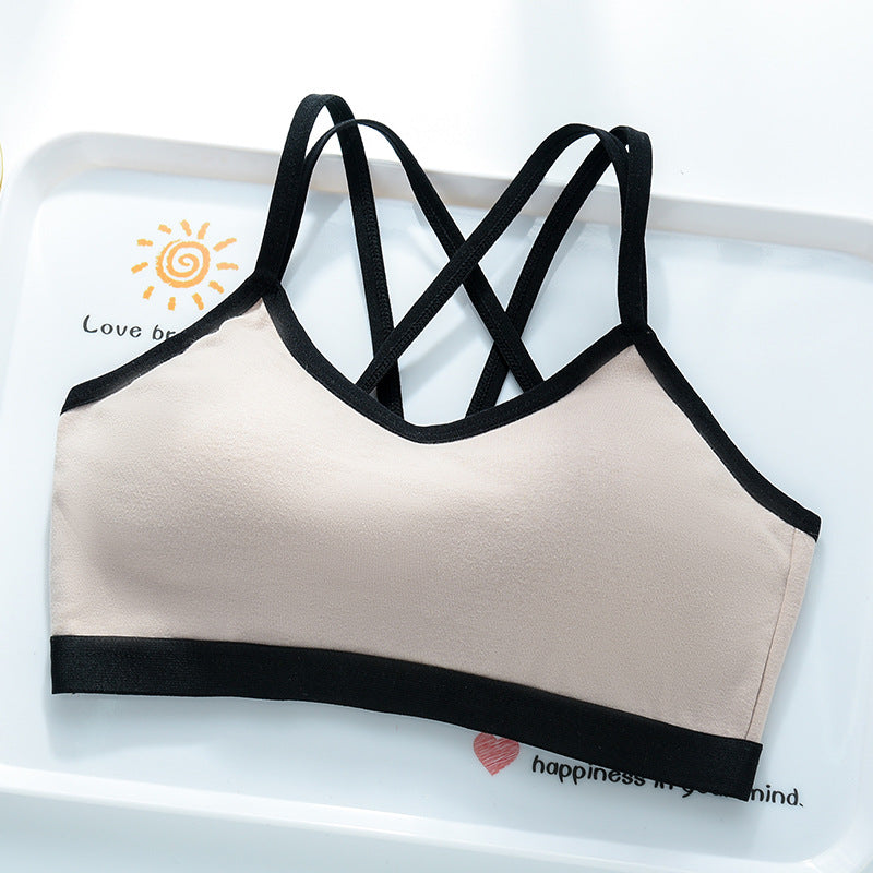 Beige milk coffee bra top with black trim and black crossed back straps on a white tray, Beige option, size M