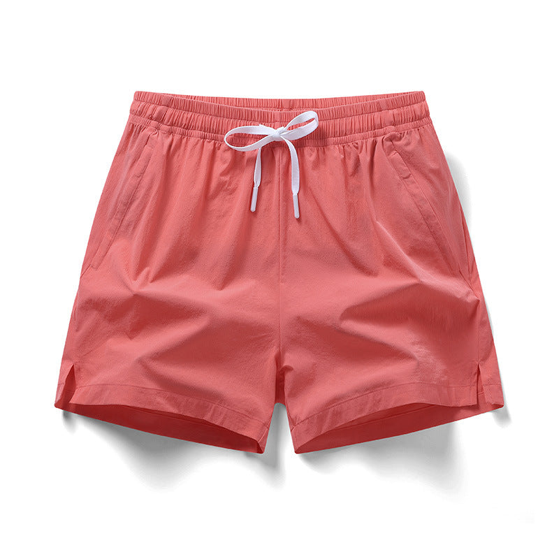 Man wearing the fluorescent green athletic training shorts in a casual street setting