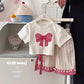 Close up of the soft bow print fabric on the girls' short sleeve set