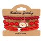 Red Christmas bracelet set on a Fashion Jewelry card with Santa and reindeer face charms
