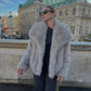 Light gray vegan fur lapel jacket on a model in front of a building, option Light Gray, size XXL