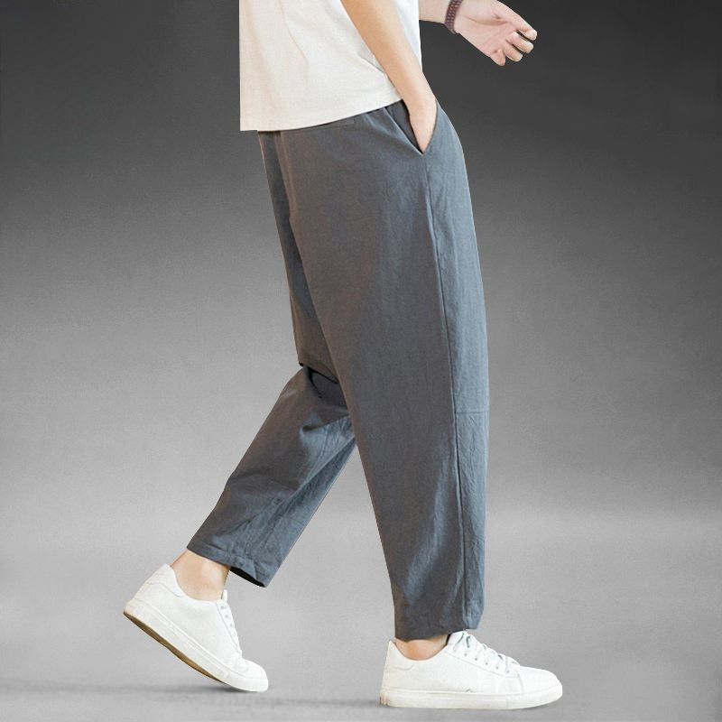 Mens loose cotton linen wide leg casual pants, ankle length with elastic drawstring waist, on model