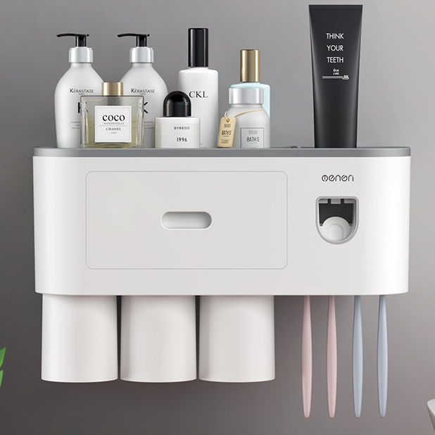White bathroom organizer with an open top tray holding bottles, a comb and a razor