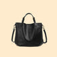 Black cowhide leather bucket tote with top handles and a shoulder strap, black option
