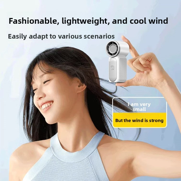 Person holding the white handheld turbo fan near the face