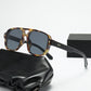 Square double bridge sunglasses with a tortoise frame and gray lenses beside a gift box