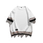 Men's round neck T-shirt shown at an angle with the ribbed crew collar