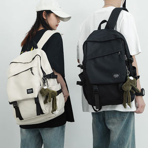 Simple polyester laptop backpack with a front flap pocket and side pockets shown from the front