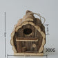 Pine bird house resting on a wooden garden table