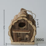 Pine bird house resting on a wooden garden table