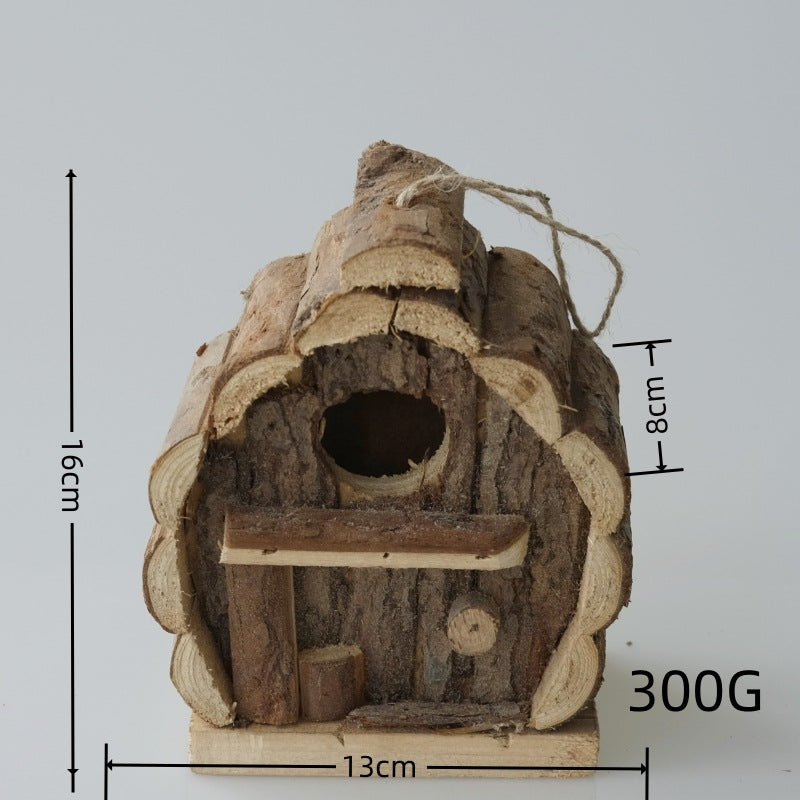 Pine bird house resting on a wooden garden table