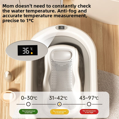 Cream and gray foldable baby bathtub with digital temperature display showing 36 degrees and mesh bath rack