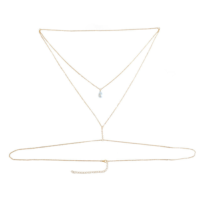 Flat lay of the pearl drop body chain with chain, clasp and extender
