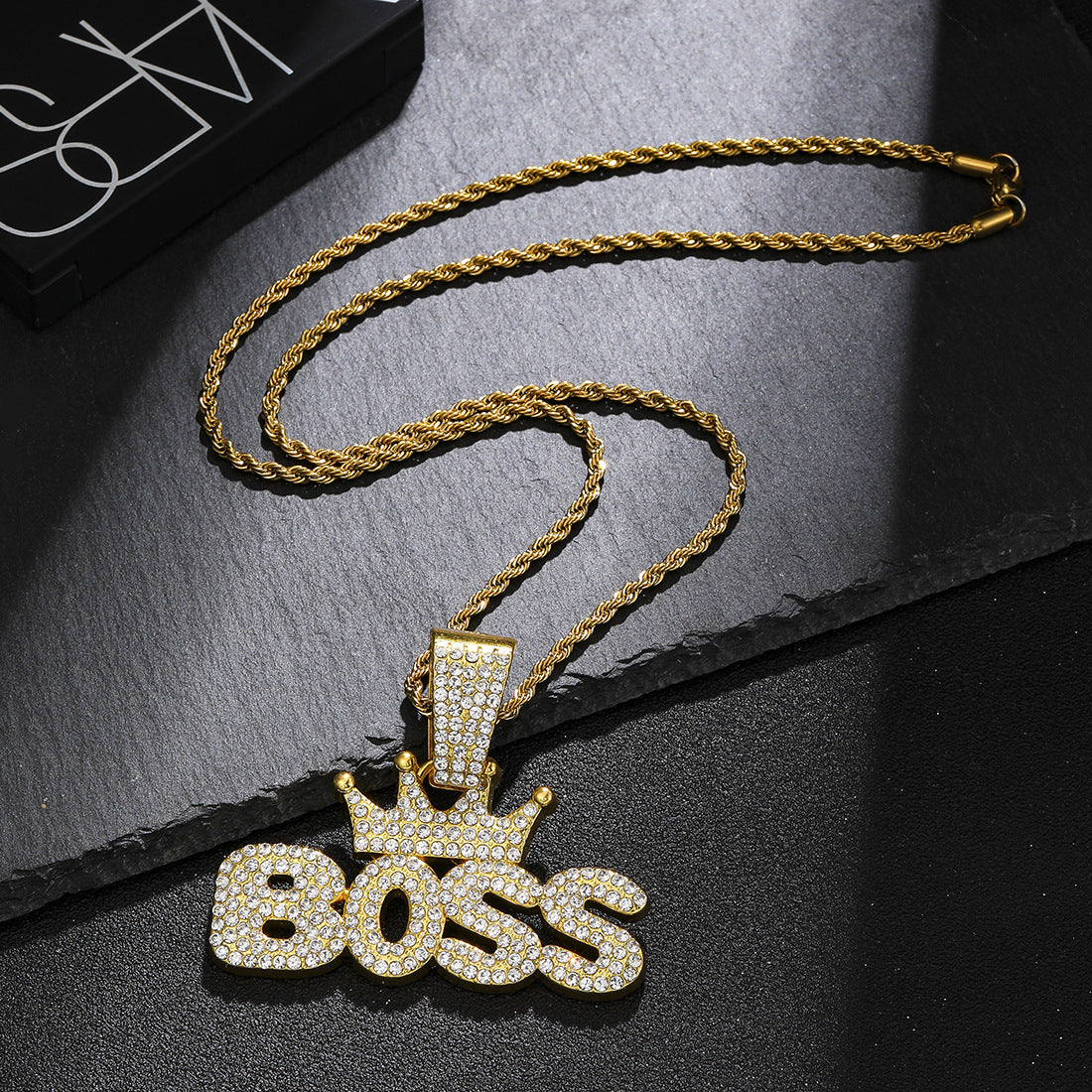 Crown pendant necklace styled in a modern interior scene