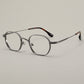 Angled hero shot of the titanium eyeglasses frame showing front and temples
