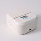 Top view of the compact white pocket printer with a toothed tear bar and a side power button