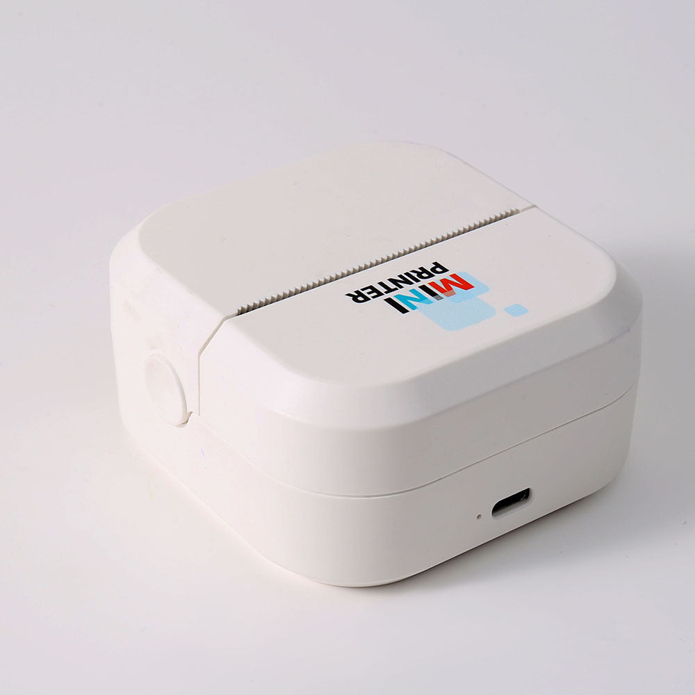 Top view of the compact white pocket printer with a toothed tear bar and a side power button