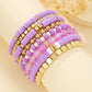 Beaded bracelet set held near a hand to show the slim stretch strands