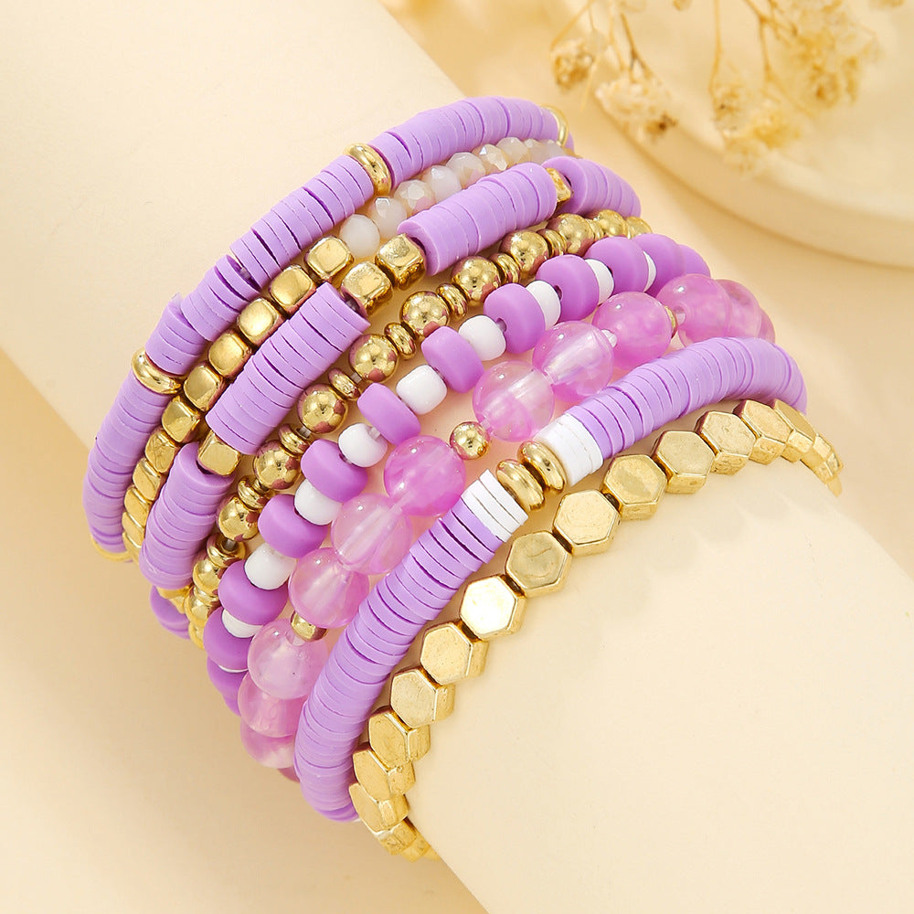 Beaded bracelet set held near a hand to show the slim stretch strands