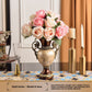 European style resin display piece with pearl shell inlay and gilt scrollwork on a tabletop scene