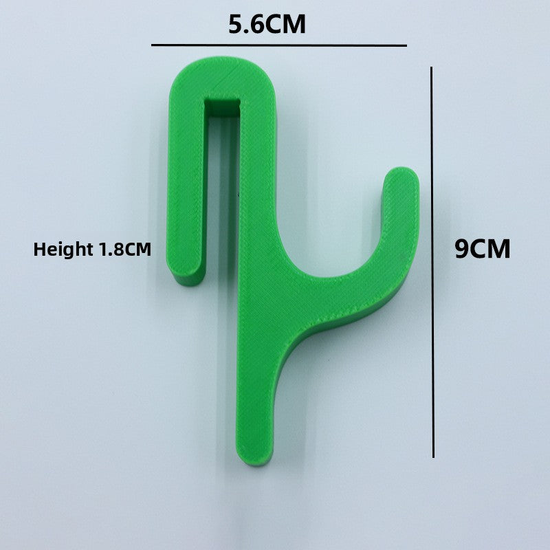 Green resin single hook with size marks, 5.6 cm wide and 9 cm tall, seen from the front on a light background