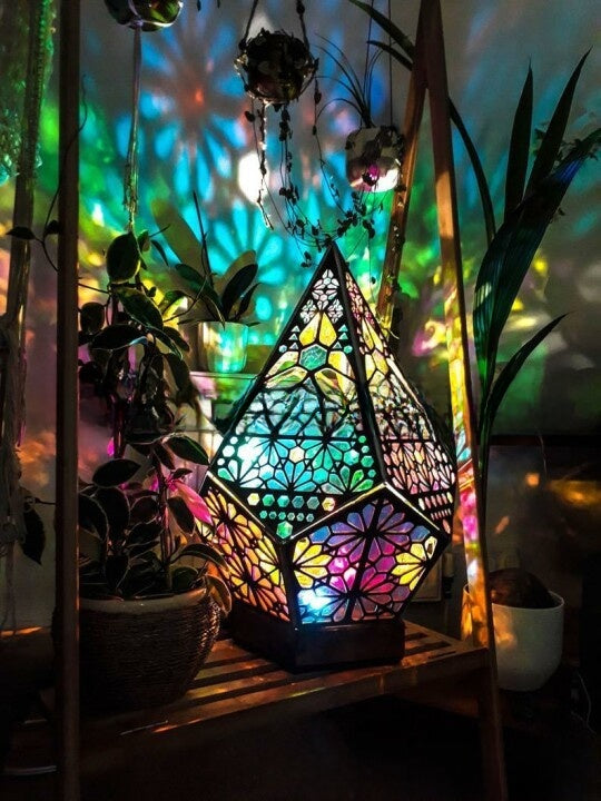 Diamond cut projection lamp on a natural wood base shown switched off as an ornament