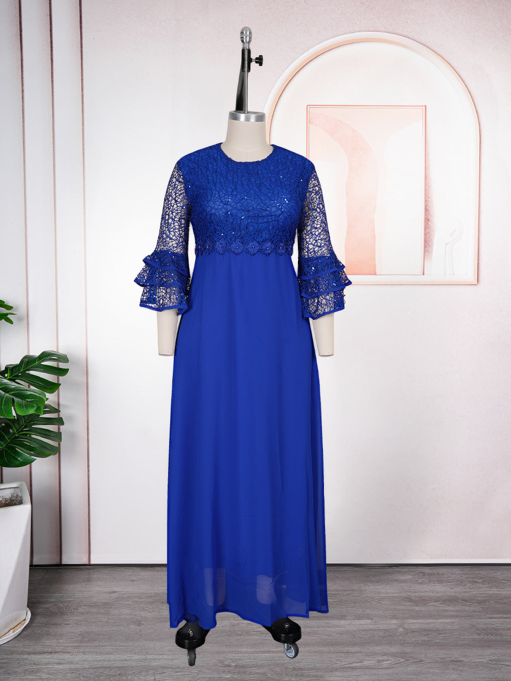 Floor length floral lace chiffon dress with tiered ruffle sleeves on a model