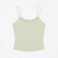 Fitted spaghetti strap camisole with a scoop neck shown on a model