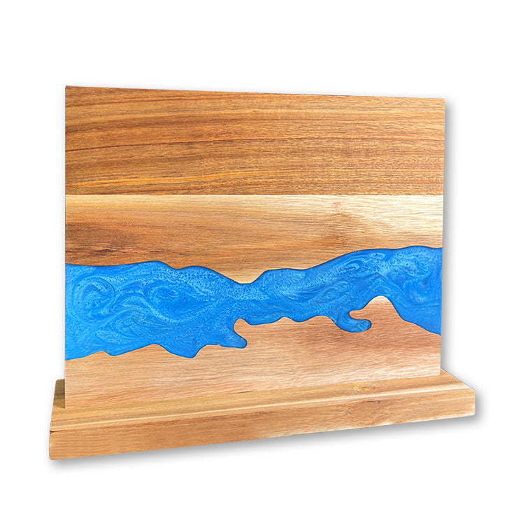 Acacia wood magnetic knife holder with a coloured resin river standing upright on its base