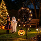 Solar garden stake light with pierced iron stars and pumpkin lanterns glowing in the yard