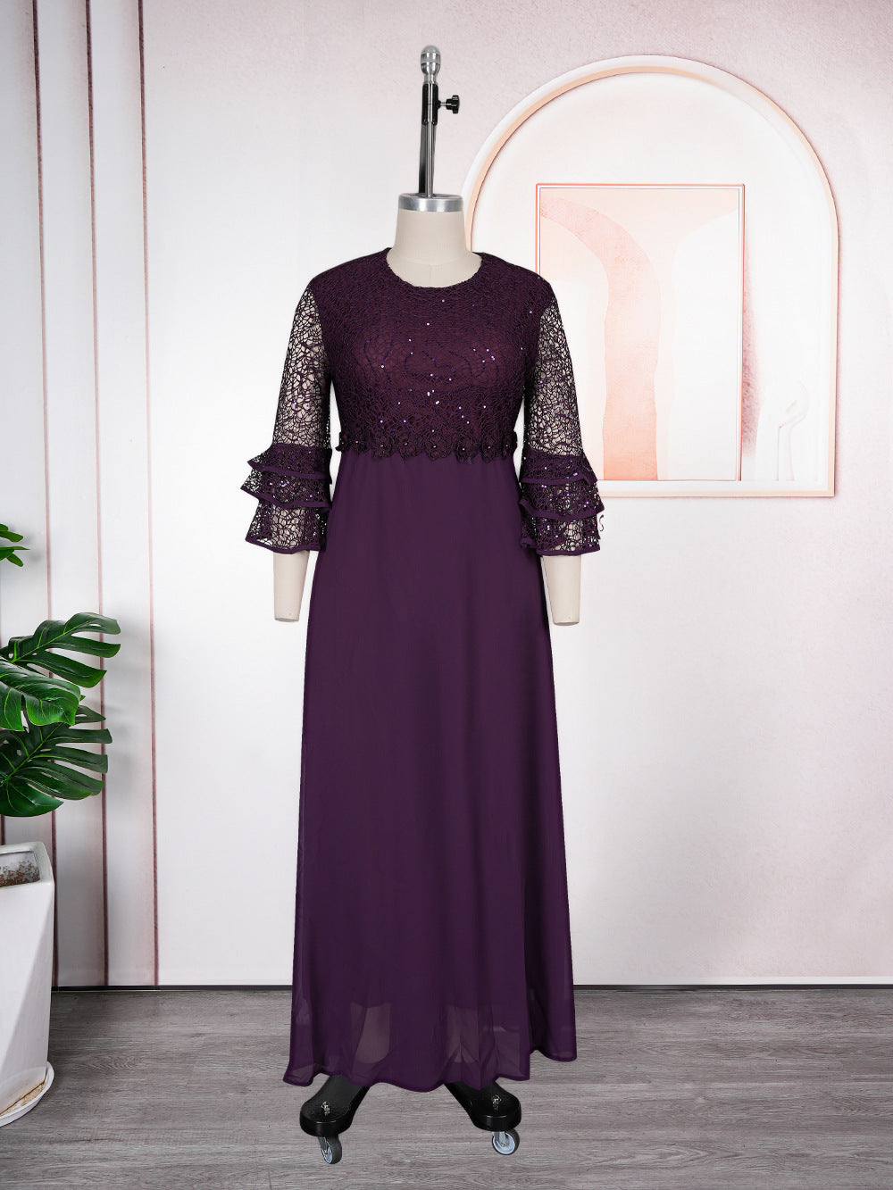 Floor length floral lace chiffon dress with tiered ruffle sleeves on a model