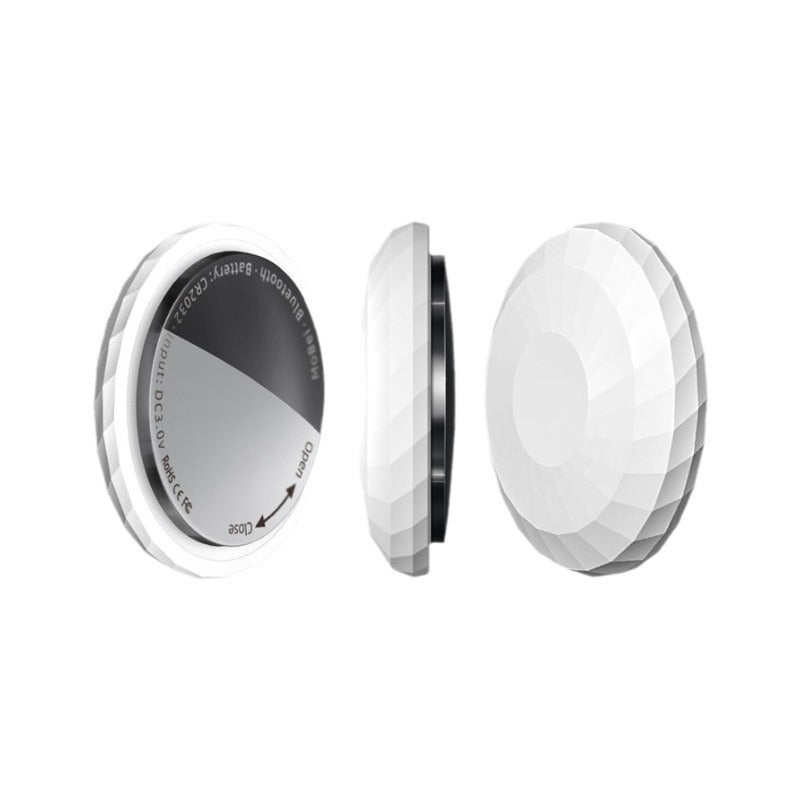 Small round Bluetooth item finder tag shown close up on a plain background