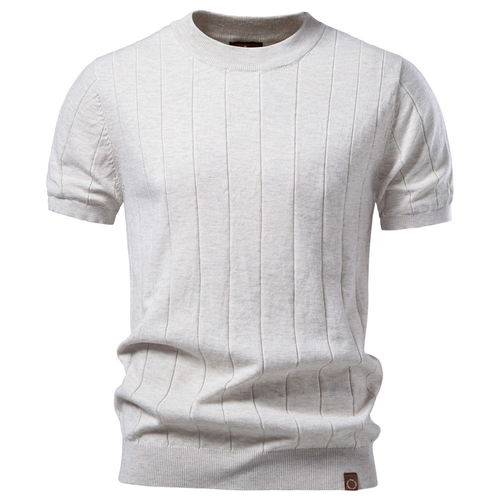Cotton short sleeve knit top laid flat to show the crew neck and even knit rows