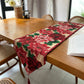 Christmas table runner with red poinsettia pattern and tassel on a wooden table, 33x300 cm option