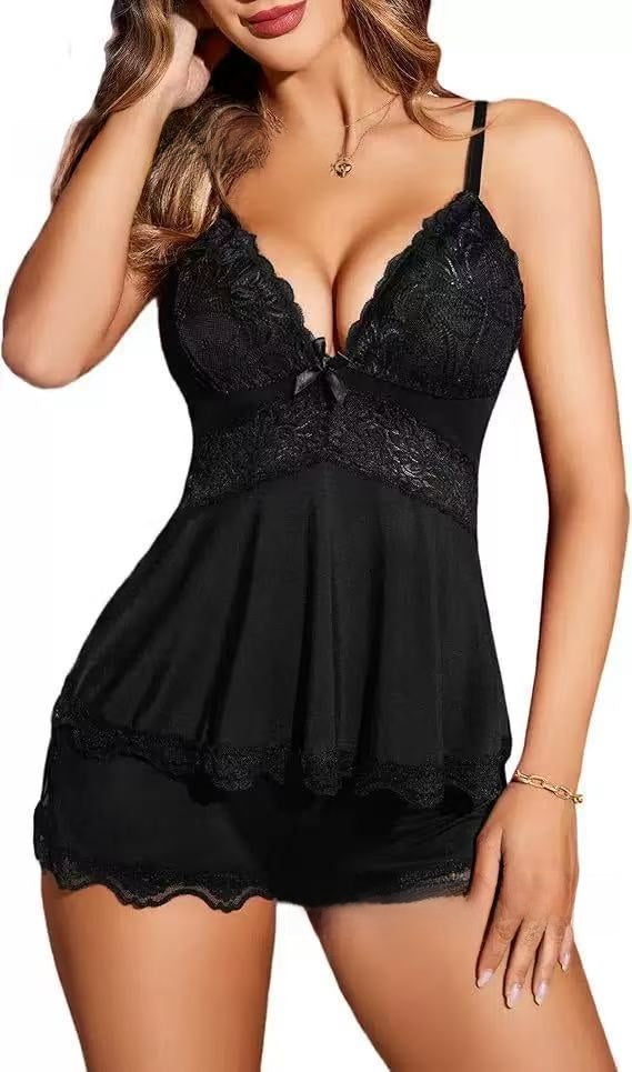 Two piece lace sleepwear set with a V neck camisole and matching shorts on a plain studio background