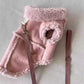 Brown faux suede dog vest with curly sherpa lining shown from the inside