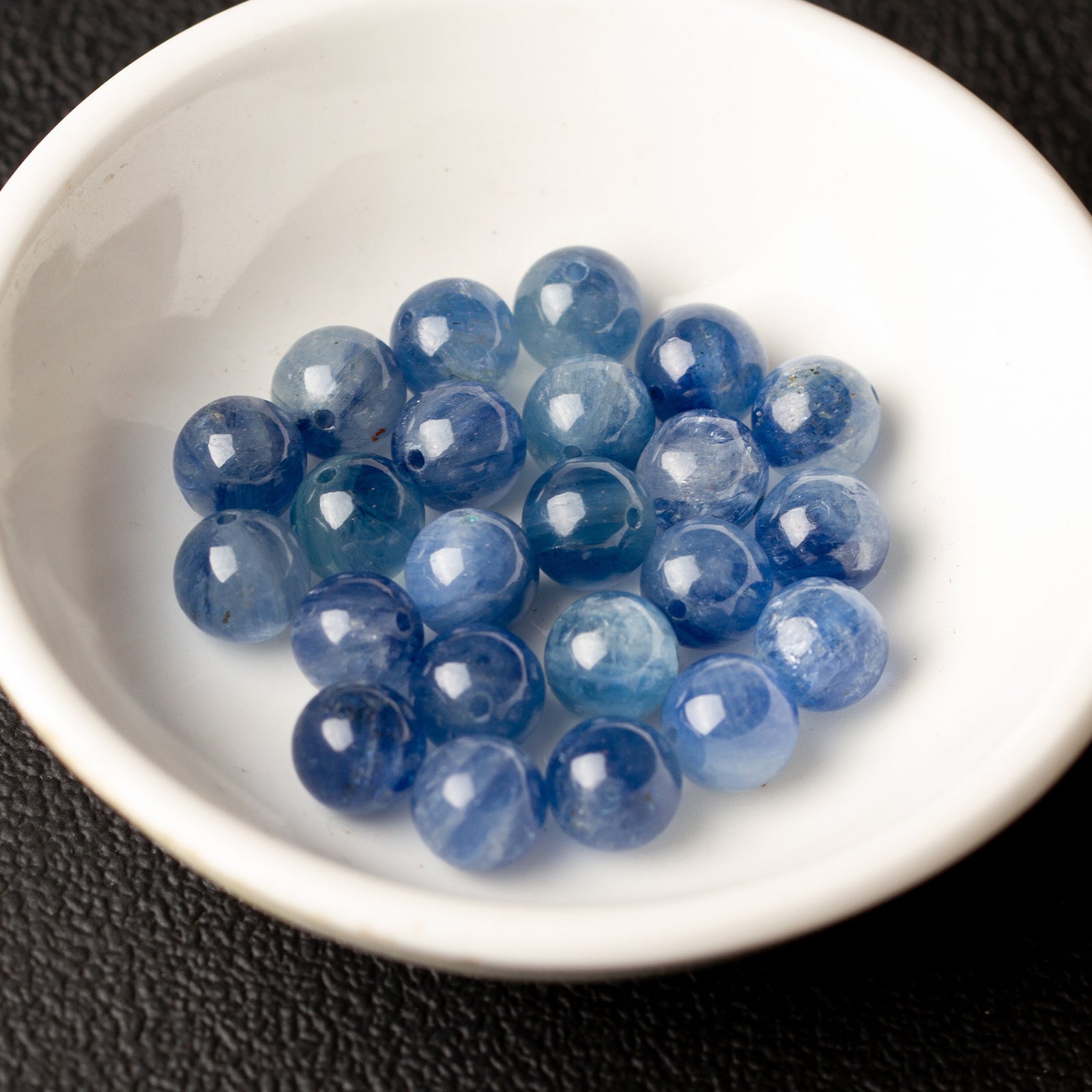 Natural blue kyanite round beads drilled through the center for jewelry stringing