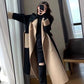 Self tie belt and camel patch pockets detail on the black wool blend coat