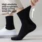 Black mid calf bamboo socks worn and stretched by hand beside a long lasting wear feature panel