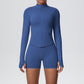 Womens seamless activewear set with a long sleeve zip jacket and matching high waist shorts