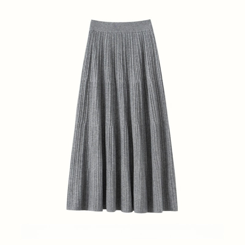 Light gray ribbed A-line midi skirt with tiered seams and a wide waistband, flat view on a white background