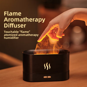 Black flame effect diffuser and humidifier glowing on a wood table with a hand near the mist