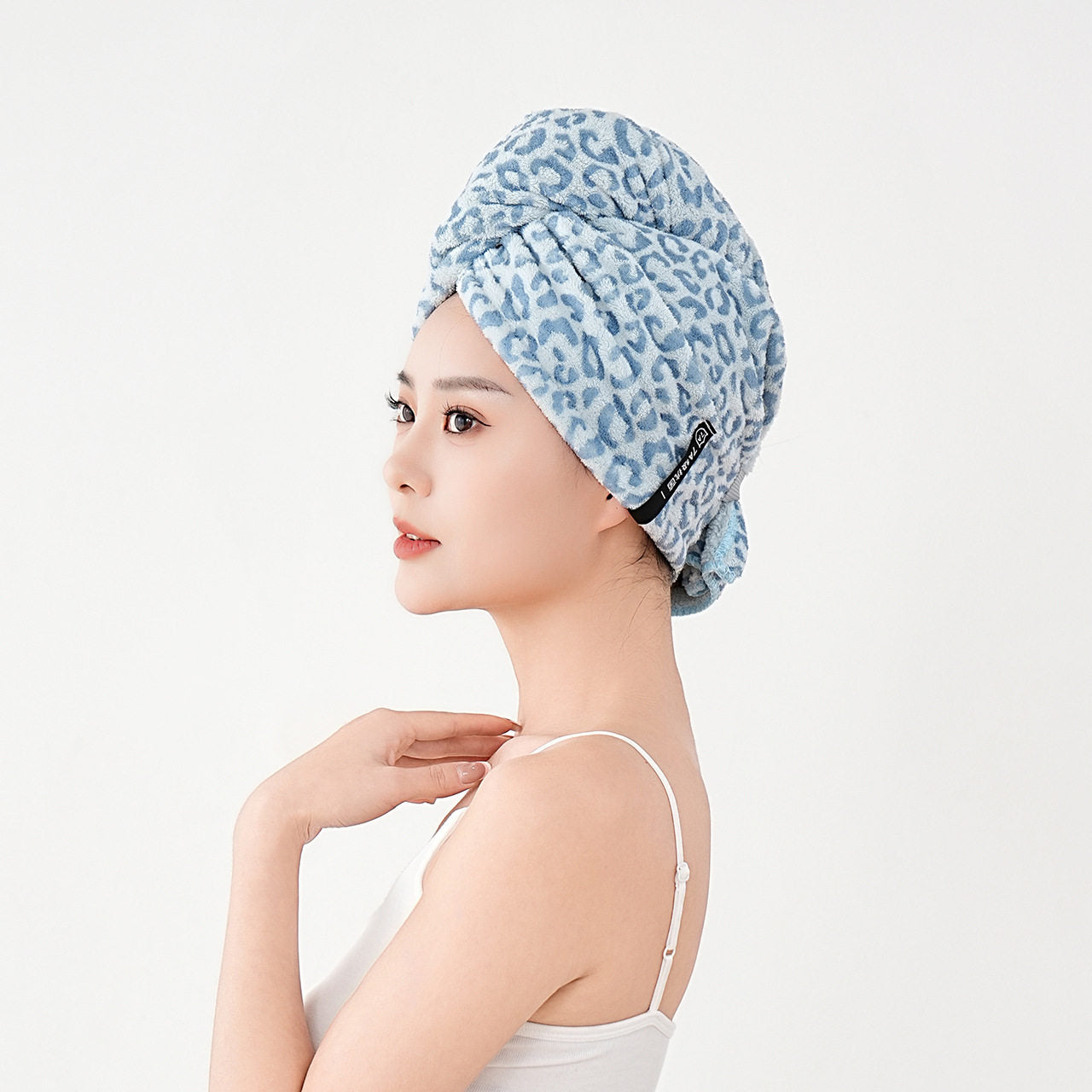 Towel hair wrap styled at an angle on wet hair after a shower