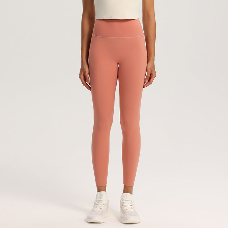 Second-skin nylon spandex yoga leggings with high waistband, shown on a studio model