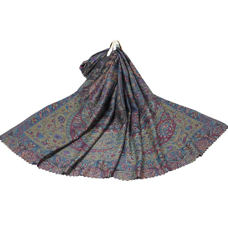 Dark navy paisley shawl with a teal and gold border laid out on a white background