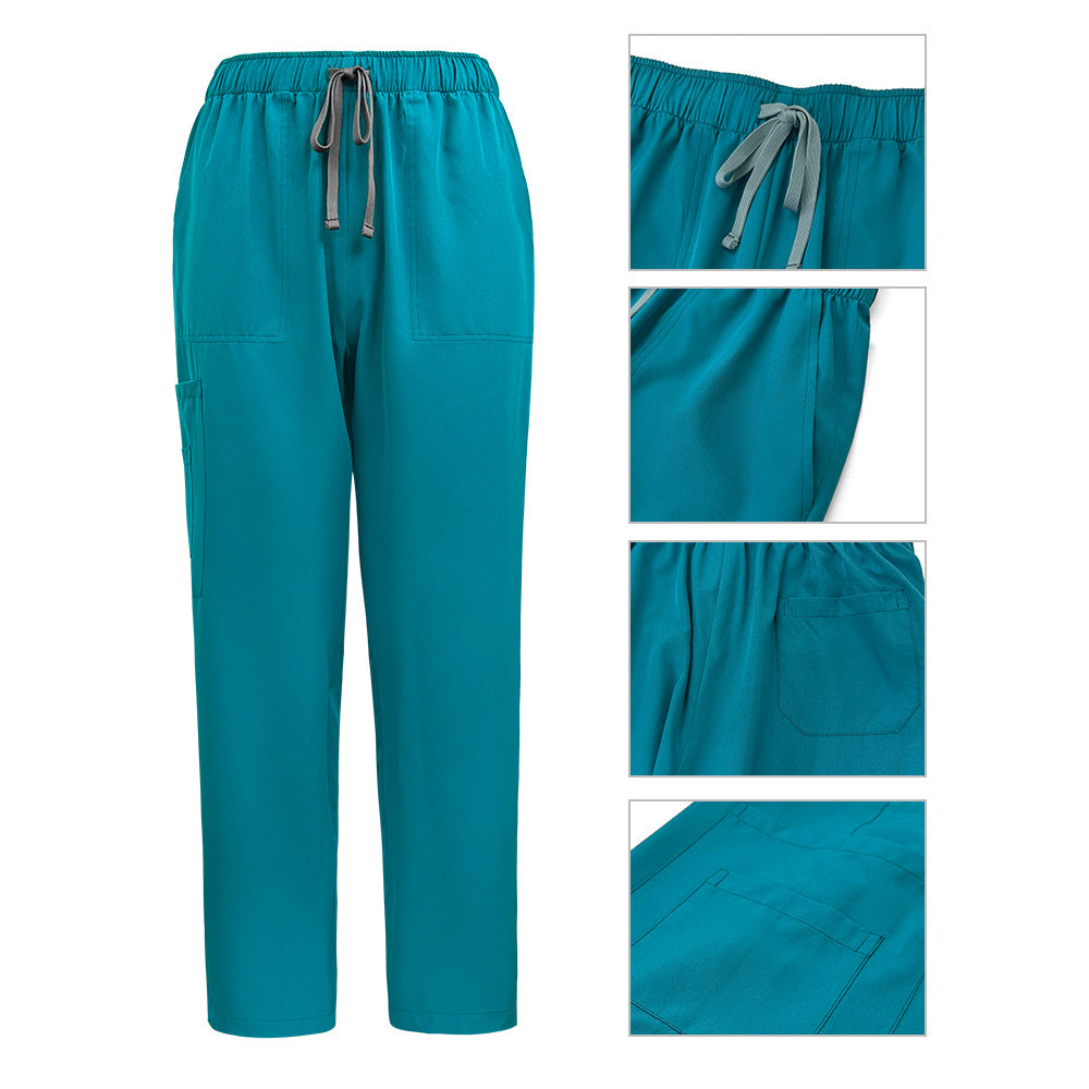 Womens scrub top in black shown flat to display the stand collar, quarter zip and hip pockets