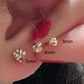 Mini heart gold stud earring shown next to thin hoops for a stacked ear set